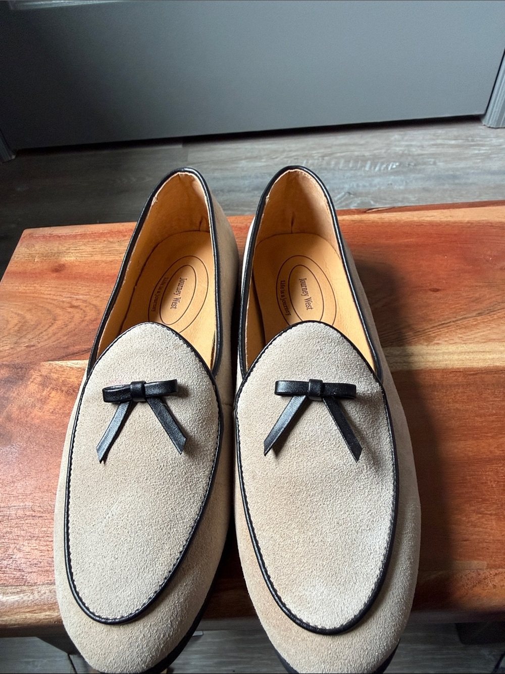 Men's Beige Suede Loafers with Black Trim and Bow Accent